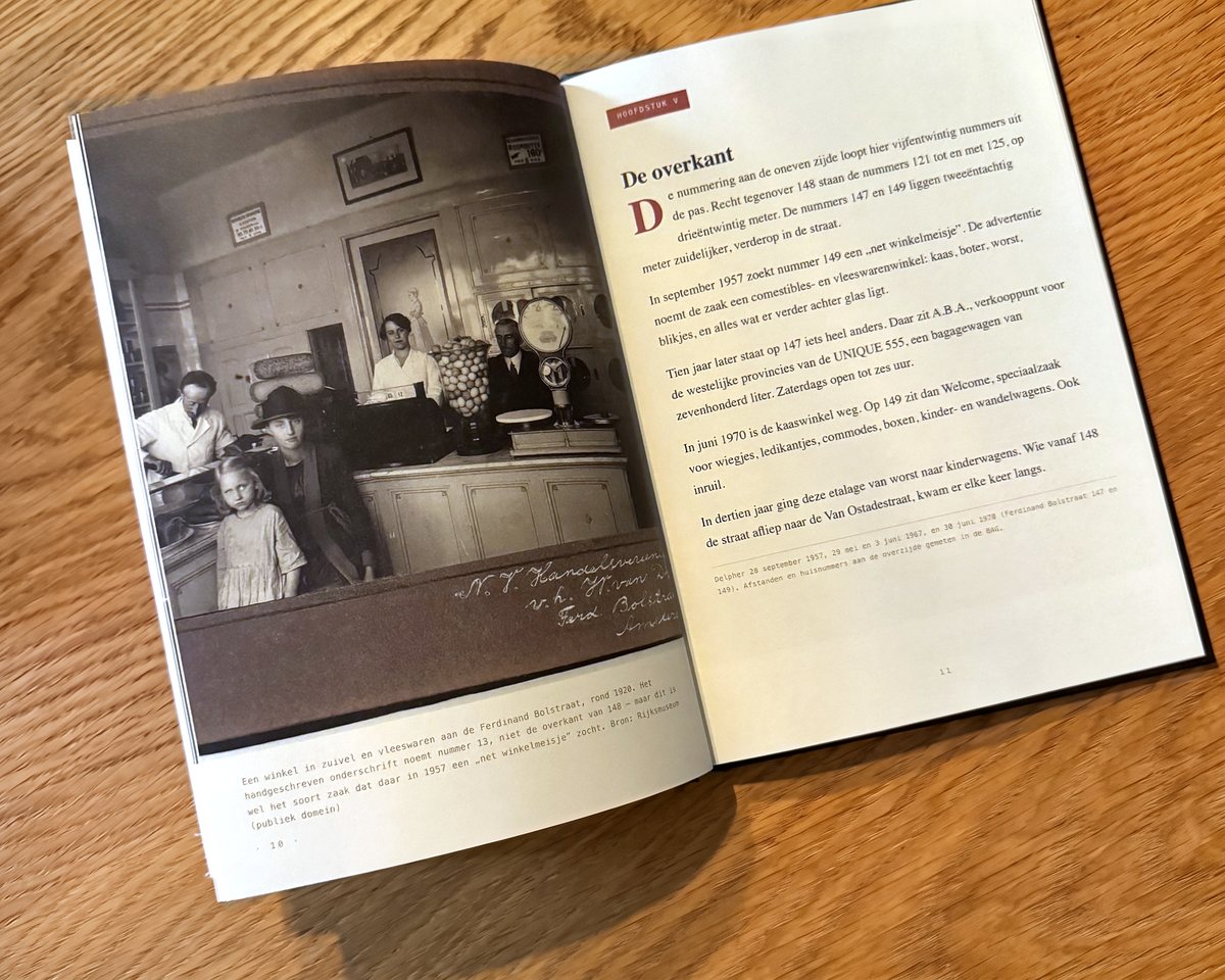 De proefdruk opengeslagen op tafel: links een archieffoto van een winkel rond 1920 met een bijschrift, rechts het hoofdstuk „De overkant” met een bronregel eronder